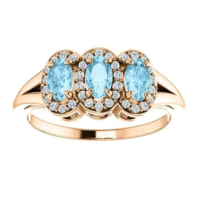 14KT GOLD .60 CTW AQUAMARINE & .16 CTW DIAMOND 3 STONE HALO RING