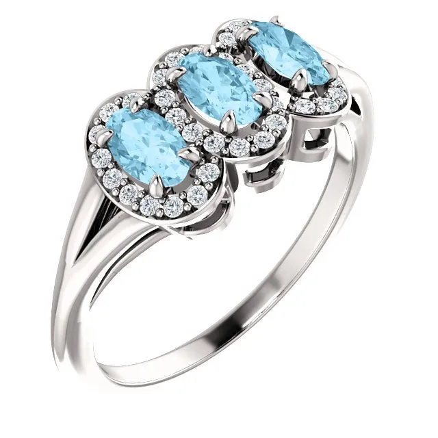 14KT GOLD .60 CTW AQUAMARINE & .16 CTW DIAMOND 3 STONE HALO RING